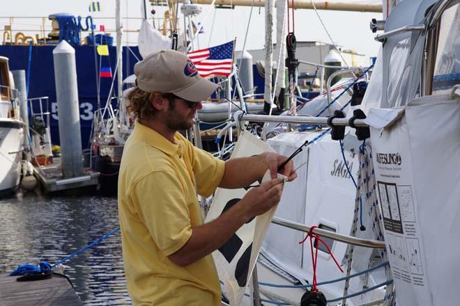 Jake is outfitting all boat with a number banner from Chesapeake Sailmakers. © World Cruising Club http://www.worldcruising.com